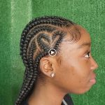 A woman with a braided hairstyle, looking elegant and stylish.